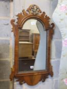 A George III style walnut fret cut and carved giltwood wall mirror, width 49cm, height 86cm