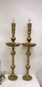 A pair of Benares engraved brass floor lamps 89cm