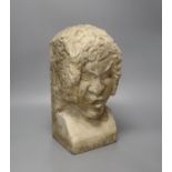 A carved sandstone grotesque bust, stonemason’s mark to back, 36cm