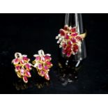 A modern 585 yellow metal, ruby and diamond cluster dress ring, size T and a pair of matching