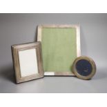 Three assorted silver mounted photograph frames, largest 27.3cm.