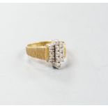 A 1970's textured 18ct gold and thirteen stone diamond set geometric dress ring, size Q, gross