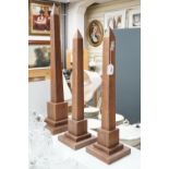 A large pair of contemporary hardwood obelisks, plus two others located throughout the property