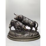 After Luis Moreno Cutando. A bronze group of two bullsstanding upon a naturalistic base with