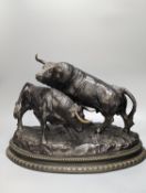 After Luis Moreno Cutando. A bronze group of two bullsstanding upon a naturalistic base with