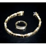 A modern 14k yellow metal and diamond chip set line bracelet, 18cm and a matching ring, size O/P,