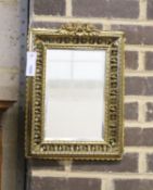 An early 20th century rectangular pierced brass wall mirror with cherub pediment, width 29cm, height