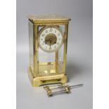 A French brass four glass clock, key and pendulum 27cm