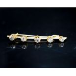 A yellow metal and five stone diamond set bar brooch, 45mm, gross weight 2.8 grams.