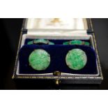A pair of white metal mounted carved jade cufflinks, largest panel approx. 25mm.