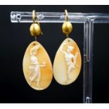 A pair of Victorian yellow metal and cameo shell ovoid earrings, carved with Mercury & Flora,