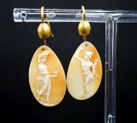 A pair of Victorian yellow metal and cameo shell ovoid earrings, carved with Mercury & Flora,