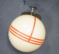 An Art Deco style chrome and cream globular shaded ceiling light with orange trailed decoration,