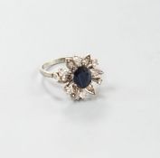 A 1930's 18ct white gold, sapphire and diamond cluster set flower head ring, size Q/R,gross weight 6