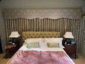 A pair of embroidered woven silk curtains, with pelmet, decorated with pink roses on a eau de nil