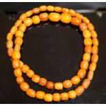 A single strand amber bead necklace, 82cm, gross 69 grams.