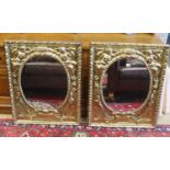 A pair of late 19th/early 20th century Dutch embossed brass framed mirrors with oval plates, width