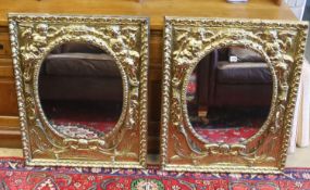 A pair of late 19th/early 20th century Dutch embossed brass framed mirrors with oval plates, width