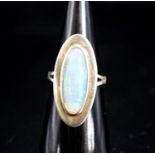 A 9ct white gold and oval cabochon white opal set dress ring,size M, gross weight 6.9 grams.