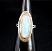 A 9ct white gold and oval cabochon white opal set dress ring,size M, gross weight 6.9 grams.