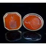 Two 19th century yellow metal overlaid and carnelian set fob seals, largest 43mm.