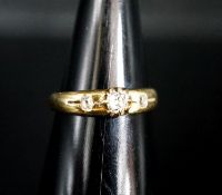 An 18ct and three stone claw and gypsy set diamond ring, size O/P, gross weight 4.2 grams.