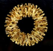 A 1970's textured 18ct gold modernist circular pendant, 35mm, 16 grams.