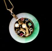 A yellow metal and gem set mounted jade disc pendant, 30mm on s yellow metal fine link chain,