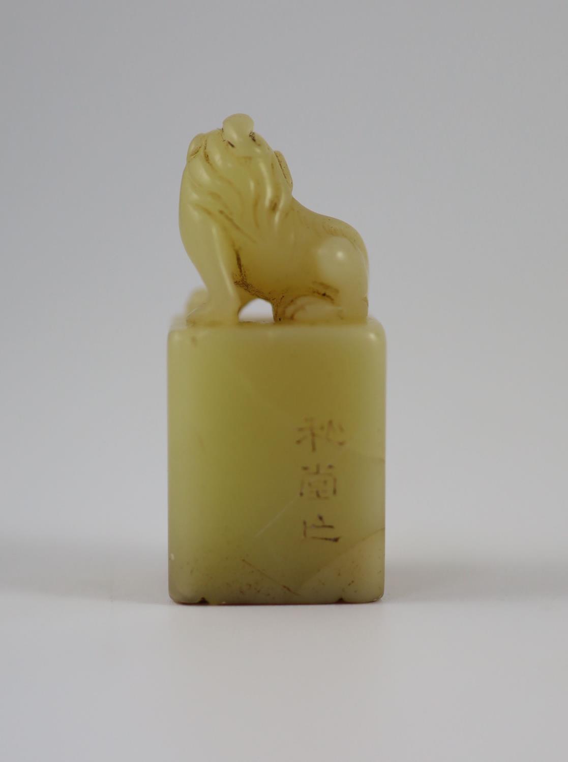 A Chinese inscribed cream coloured soapstone seal,of square section, surmounted by the figure of a - Image 2 of 4