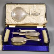 A cased George V six piece mirror and brush set.