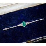 A boxed 1920's white metal (stamped pt), emerald and diamond chip set bar brooch, 51mm, gross weight
