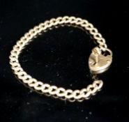 A yellow metal curb link bracelet with heart shaped clasp, with key, 20cm including clasp,10.8