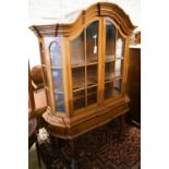 An 18th century style Dutch walnut display case, with double-arched moulded cornice over a pair of