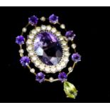 An early 20th century yellow metal, amethyst and peridot set drop oval brooch, in the suffragette