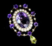 An early 20th century yellow metal, amethyst and peridot set drop oval brooch, in the suffragette
