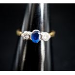 A modern 18ct gold, sapphire and diamond set three stone ring, size L/M, gross 3 grams.