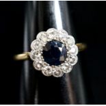 An 18ct, sapphire and diamond set circular cluster ring, size M, gross weight 2.4 grams.