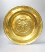 A large Nuremberg brass alms dish, 17th century, depicting Adam and Eve within a twisted foliate and