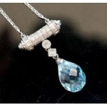 A modern 750 white metal, facet cut pear shaped aquamarine and diamond chip set drop pendant,