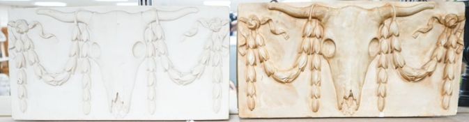 A composite simulated marble plaque, decorated with a skull and garlands, plus another (2) 25x50cm