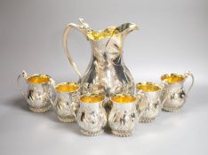 A good set of six Garrard & Co Ltd silver mugs and a matching jug, London, 1997, all embossed with
