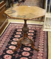 A Victorian burr walnut octagonal topped tea table, raised on leaf carved pillar and open scrolled