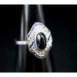 A 1920's white metal (stamped plat), sapphire and diamond ring, with central cabochon sapphire, size