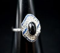 A 1920's white metal (stamped plat), sapphire and diamond ring, with central cabochon sapphire, size