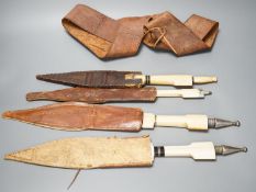 Four similar African tribal daggers c.1900, each with hippo tusk handle including two with silver