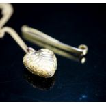 A 9ct tie pin and a yellow metal heart shaped pendant on a 9c fine link chain, gross weight 5.9