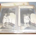 An early 20th century postcard collection in two albums and an empty late Victorian leather photo