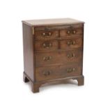 A George III mahogany chest,fitted brushing slide, four short and two long drawers on bracket feet,