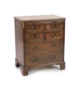 A George III mahogany chest,fitted brushing slide, four short and two long drawers on bracket feet,