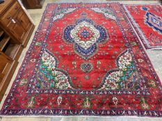A Tabriz red ground carpet, 380 x 300cm